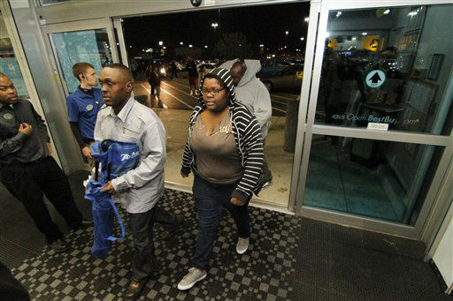 Shoppers rush into a north Jackson, Miss., Best...