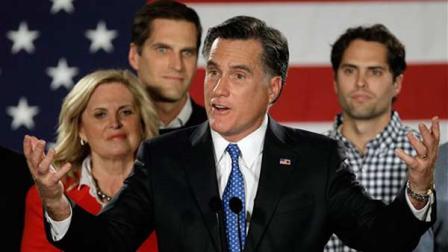 Republican presidential candidate, former Massachusetts Gov. Mitt Romney address supporters with his wife Ann and their sons behind him during a Romney for President Iowa Caucus night rally in Des Moines, Iowa, Jan. 3, 2012