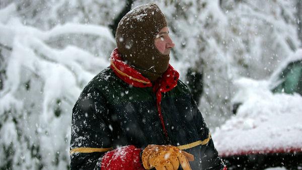 Person with layers of clothing on during storm
