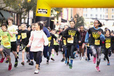 Children from kindergarten through eighth grade take off from the starting line during the Kids Running for Kids fundraising event Saturday at Market Street in The Woodlands. <span class=meta>Michael Minasi/HCN</span>