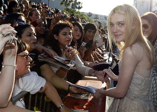 Actress Dakota Fanning signs autographs at the premiere of 'The Twilight Saga: Eclipse' on Thursday, June 24, 2010 in Los Angeles.